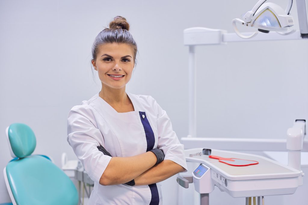 young-positive-female-dentist-doctor-with-folded-a-2022-03-16-22-18-53-utc